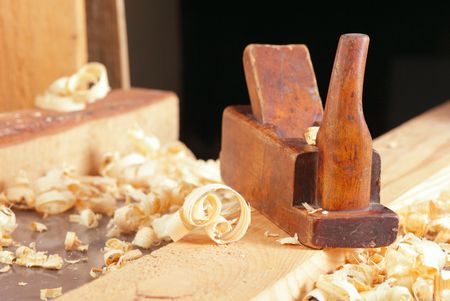 Old wooden plane and shaving