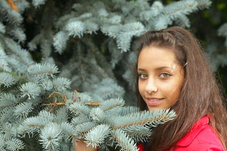 The girl near to a fur-treeの写真素材