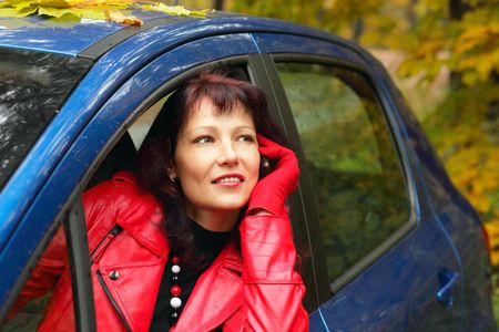 woman in red jacket  with phoneの写真素材