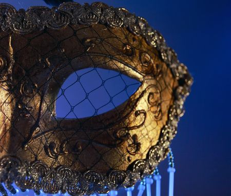  golden Venetian mask in blue lightの写真素材