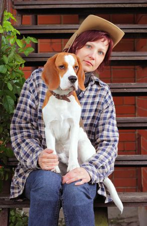 rural woman with beagle puppy,focus on a dogの写真素材