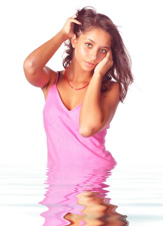beautiful girl in pink dress in waterの写真素材