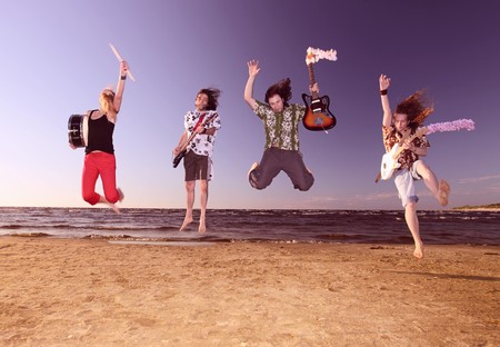 Musicians on seacoast before a sunset.Blured in motion.の写真素材
