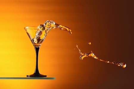 glass with martini and green olives.の写真素材