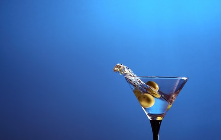 glass with martini and green olives.の写真素材