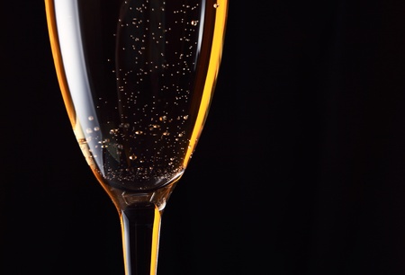 champagne in wineglass on a black background.の写真素材