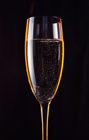 champagne in wineglass on a black background.の写真素材