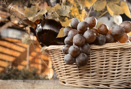 bottle with pink wine and grape in basket.old-fashioned.の写真素材
