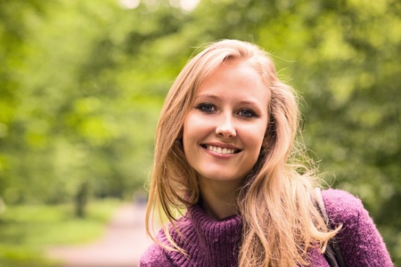 The young smiling woman in park.の写真素材