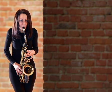  woman in black with saxophone.の写真素材