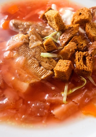 hot red soup with meat and cream.