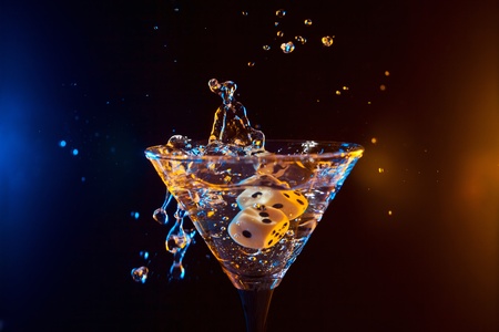 dice fall in a glass with martini.の写真素材