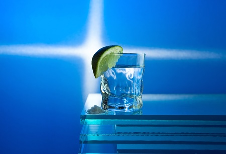 tequila and lime on a glass table.の写真素材