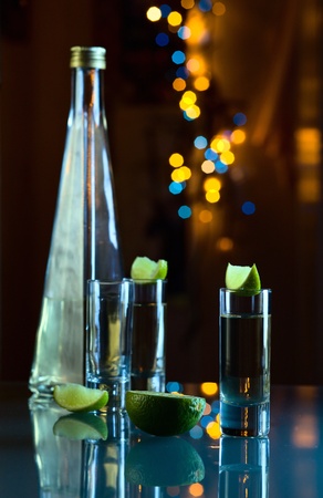 tequila and lime on a glass table.の写真素材