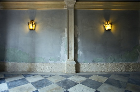 two lantern on a old wall.