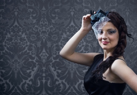 Portrait of the young beautiful girl in hat with veil.の写真素材