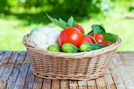 vegetables in basket on a old wood tableの写真素材