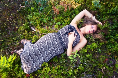 beautiful girl with long hair in forestの写真素材