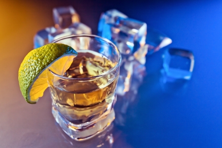 tequila , lime and ice on a glass table の写真素材