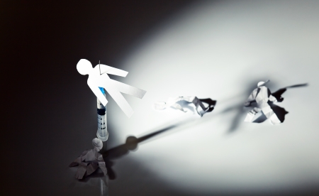 The conceptual image on a theme of narcotic dependence, a white reflective background.の写真素材