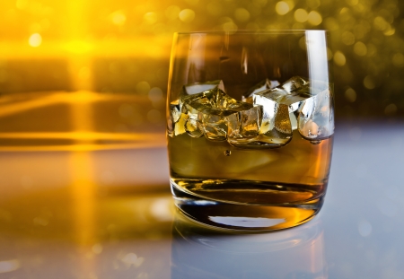 whisky with ice on a reflective backgroundの写真素材