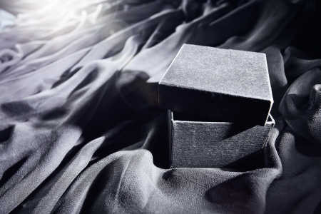 black gift box on a black textileの写真素材