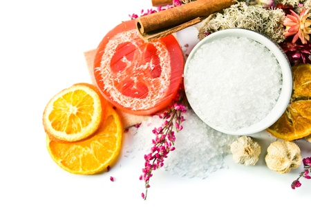 Sea salt with dried fruits, plants and flowers on white backgroundの写真素材