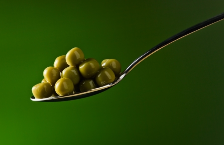 green preserved peas on a green background の写真素材