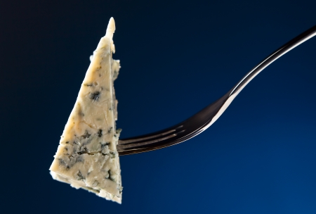 Cheese on a fork , macro shot , focus on a cheeseの写真素材