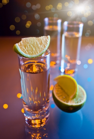 tequila and lime on a glass table.の写真素材