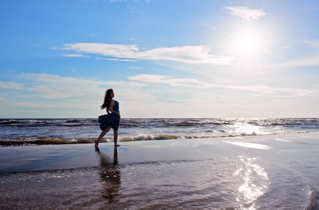 The young beautiful woman on a beach.の写真素材