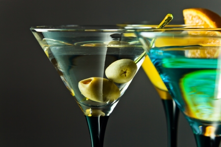 martini with green olives , focus on a olivesの写真素材