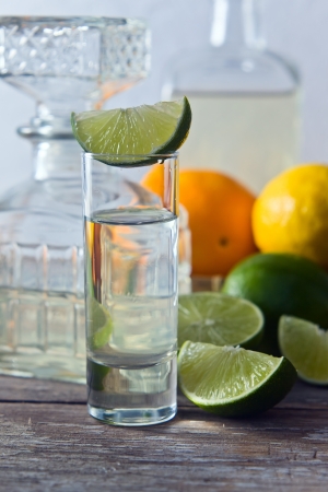tequila and citrus fruits on a old tableの写真素材