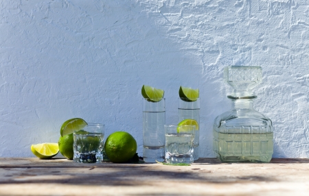 tequila and citrus fruits on a old tableの写真素材