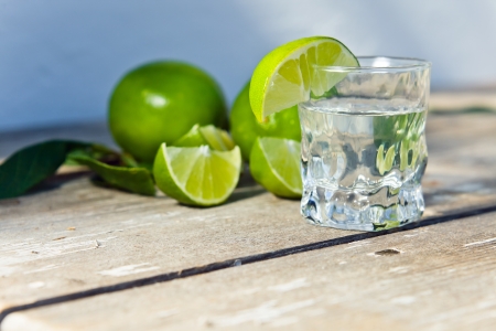 tequila and citrus fruits on a old table