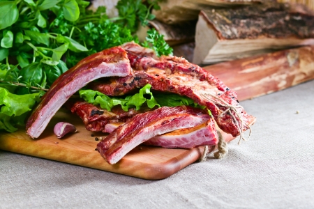 smoked meat with greens on a kitchen tableの写真素材