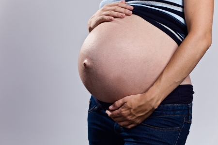 Pregnant woman holding her bellyの写真素材