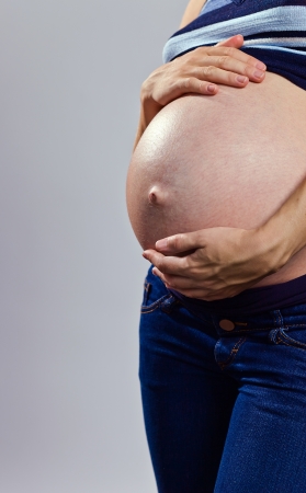 Pregnant woman holding her bellyの写真素材