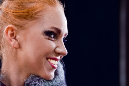 girl with red hairl in coat with fur of a fox