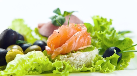 salad with salmon , greens and olivesの写真素材