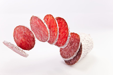 sliced salami on a white backgroundの写真素材