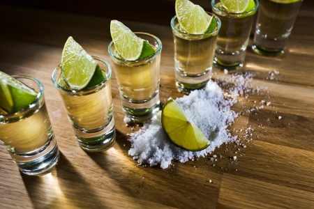 tequila , lime and salt on wooden tableの写真素材