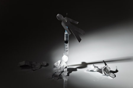 The conceptual image on a theme of narcotic dependence, white reflective background.