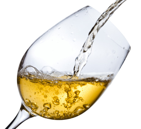 White wine being poured into a wineglass, isolated  on white ,saved clipping pathの写真素材
