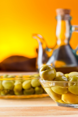 green olives on wooden table , focus on foregroundの写真素材