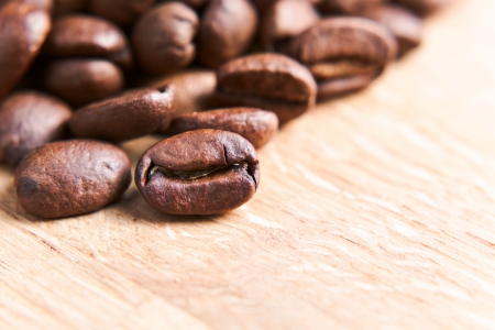 coffee beans on wooden table , focus on foregroundの写真素材