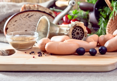 smoked sausage , rosemary and old meat grinderの写真素材