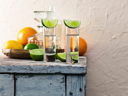 tequila and citrus fruits on a old tableの写真素材
