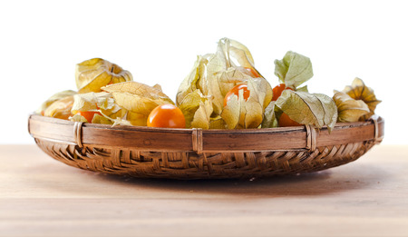 Physalis in basket on a wooden tableの写真素材