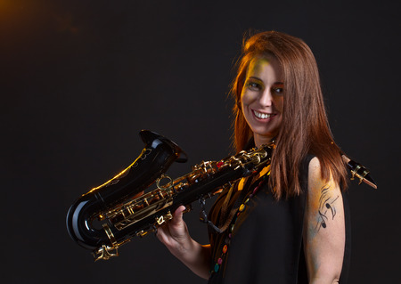 Portrait of the woman in black with a saxophoneの写真素材